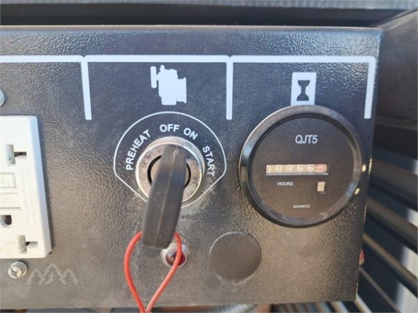A close up of the power button on an old car.
